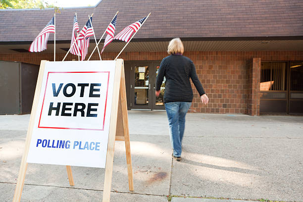 USA Election Voter Going to Polling Place Station Hz Subject: A voter approaching an election polling place station during a United States election. polling place photos stock pictures, royalty-free photos & images