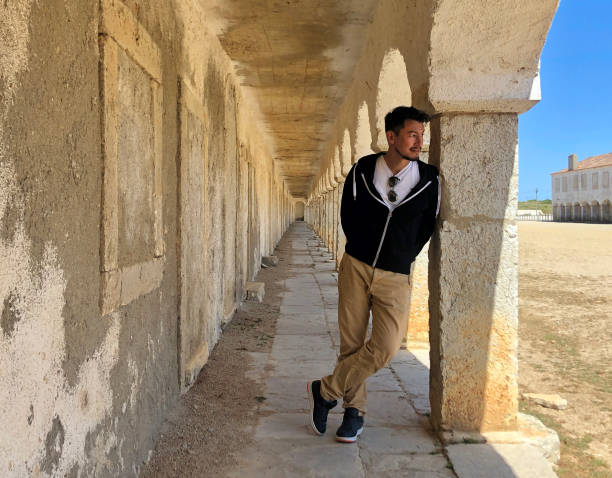 istock Man leaning against a pillar in casual clothing 1752216588