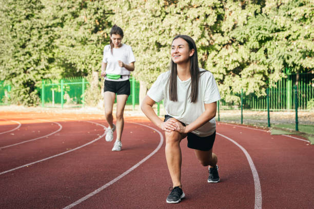 istock A young woman runner in start position on running track while work out. 1752222234