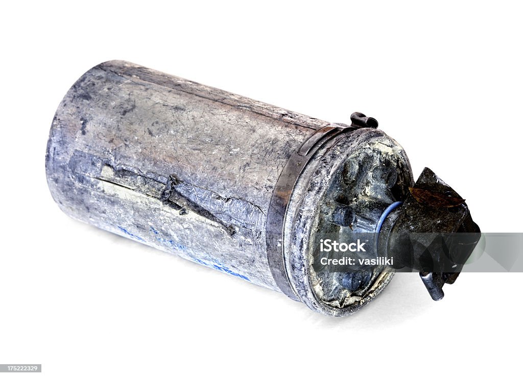 Tear gas grenade Used tear gas canister isolated on white. Tear Gas Stock Photo