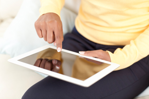 Business woman touching screen / reading news / working on digital tablet / e-book / iPod.