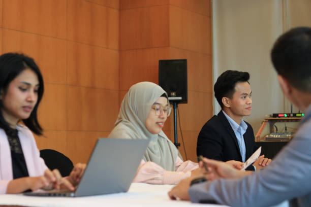istock Female moderator talking to business seminar participants 1752228084