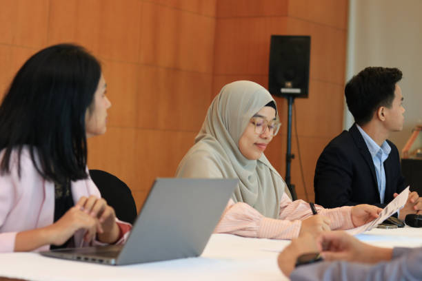 istock Female moderator talking to business seminar participants 1752228089