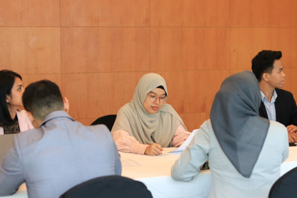 istock Female moderator talking to business seminar participants 1752228234