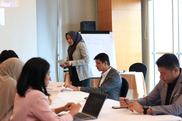 istock Female moderator talking to business seminar participants 1752229257