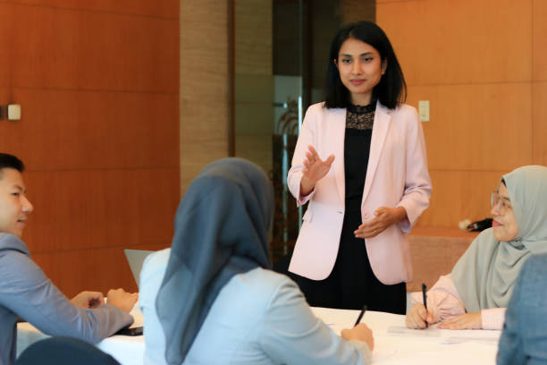 istock Female moderator talking to business seminar participants 1752231140