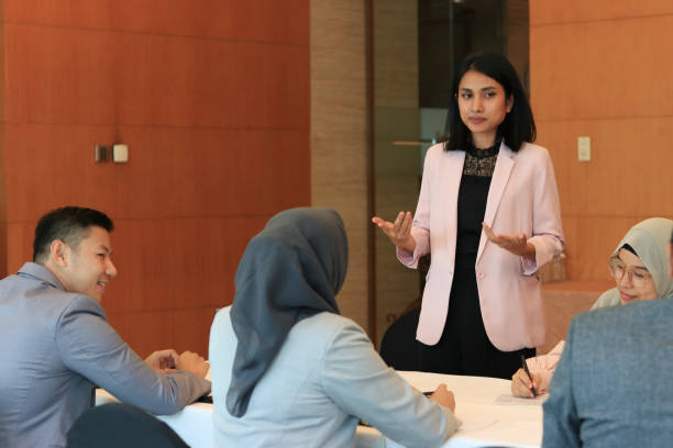 istock Female moderator talking to business seminar participants 1752231802
