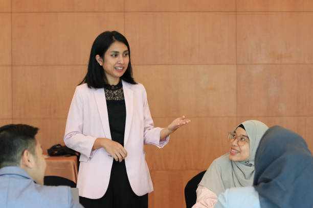 Female moderator talking to business seminar participants
