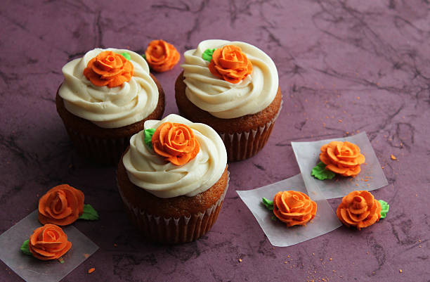 Cupcakes with rose toppers stock photo