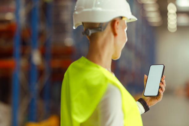 istock Caucasian female warehouse worker is using smartphone 1752246969