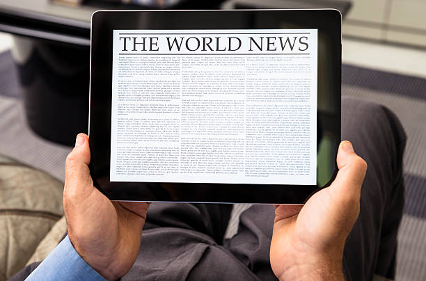 istock Man reading the newspaper on contemporary digital tablet at home 175225246
