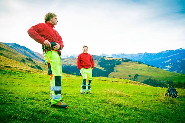 paramedics standing on alpine meadow, waiting for their next mission.