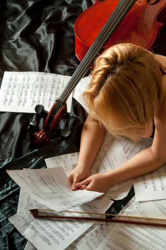 Cellist looking music sheet