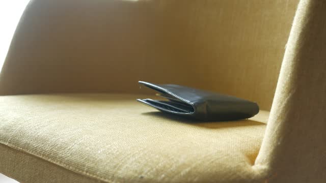 left wallet on a yellow sofa