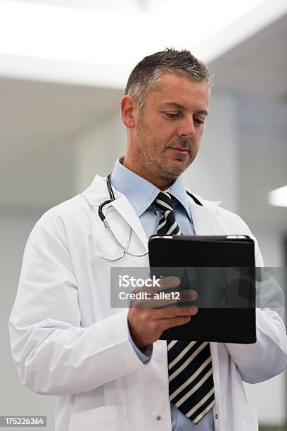 Doctor Using Touchpad Stock Photo - Download Image Now - Beautiful People, Computer, Doctor