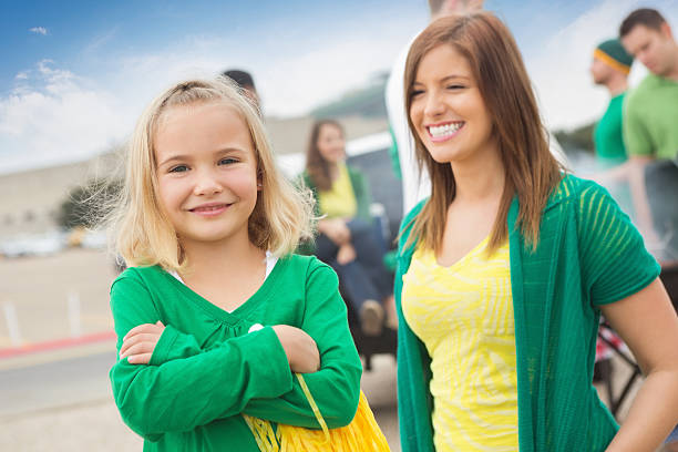 Cute little girl cheering for sports team, tailgating at stadium "Cute little girl cheering for sports team, tailgating at stadium." people family tailgate party outdoors stock pictures, royalty-free photos & images