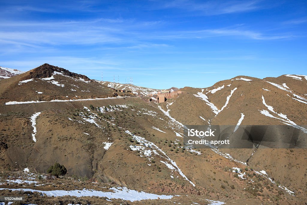 The pass Tizi-n-Tichka in Morocco The pass Tizi-n-Tichka in the Atlas mountains. It is the only route which trucks can use to reach the south eastern valleys of Morocco. At the pass there are some buildings with shops of minerals and crafts for tourists. Atlas Mountains Stock Photo