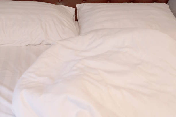 istock white pillows and white sheets on messy bed after waking up in the morning 1752270881