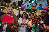 Posada Mexicana, Hispanic Family or friends Singing carols with sparklers in Christmas celebration in Mexico Latin America
