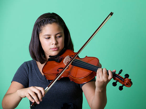 istock Young girl playing the violin. 175228239