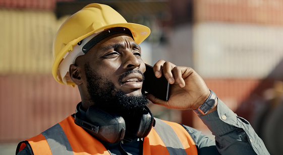 Man, phone call and outdoor logistics, thinking of container management, freight inspection or warehouse distribution. African person talking on mobile for supply chain, commercial industry or cargo