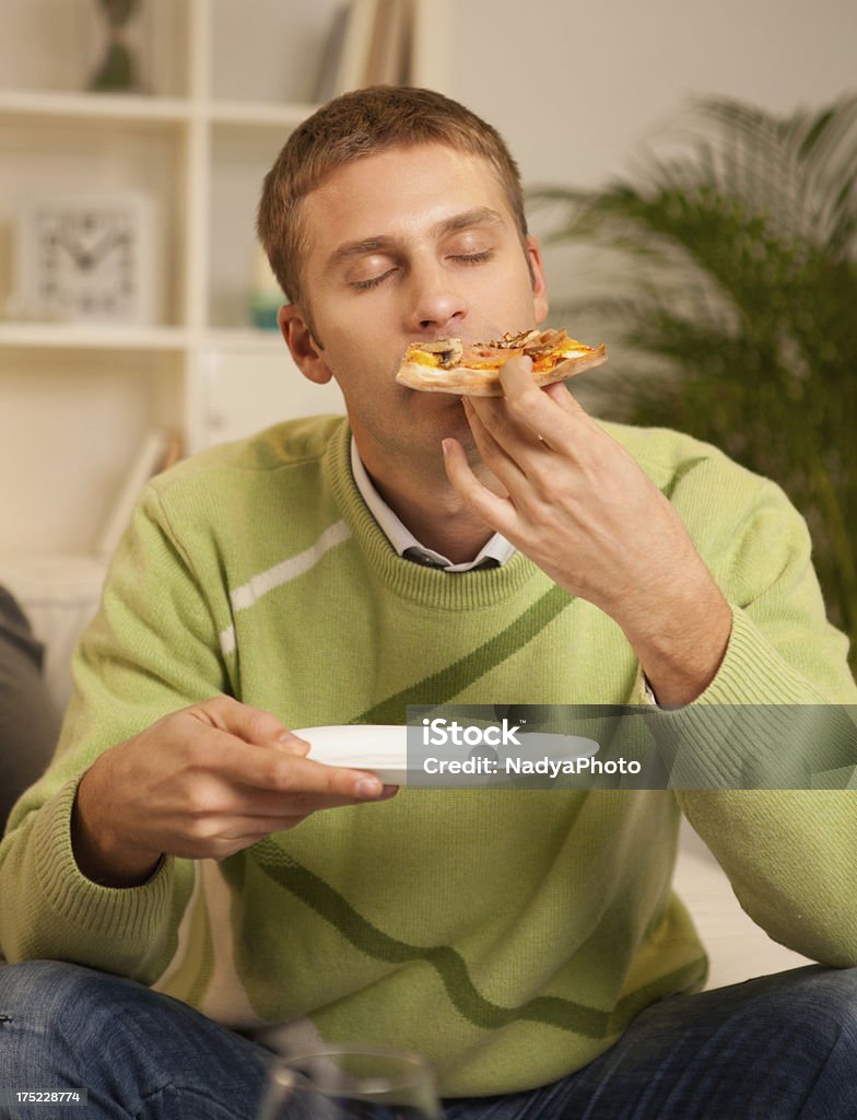 Pizza Time Close up of a man enjoying delicious pizza. Eyes Closed Stock Photo