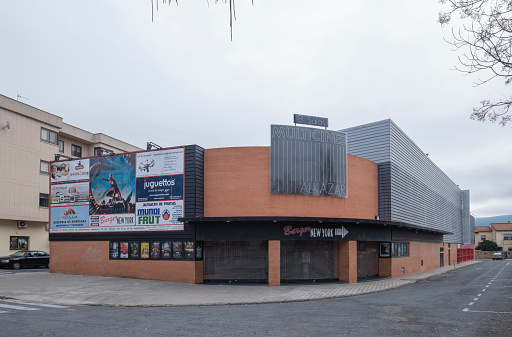 Plasencia,Caceres,Spain - December 04, 2021: Facade of the cinema or multiplex building, at its main entrance with movie posters.