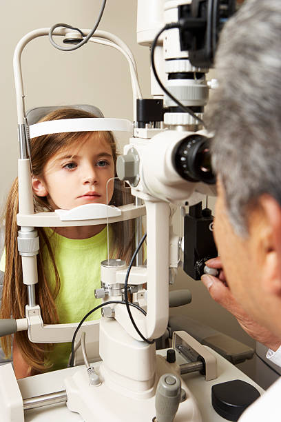istock Optician In Surgery Giving Girl Eye Test 175228942