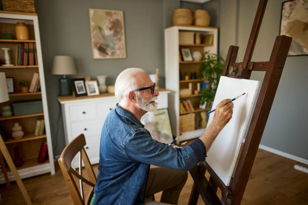 istock Elderly man painting on a canvas at home 1752290132