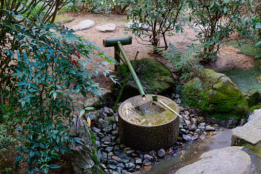 Ancient washbasin in public park, Kyoto, Japan.