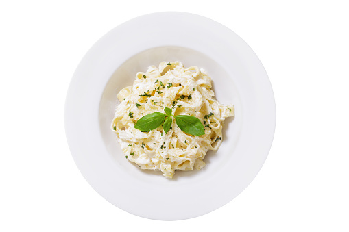 plate of pasta fettuccine alfredo isolated on white background, top view