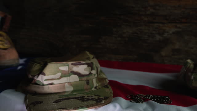 Military belongings leaved above a USA flag on veteran's day