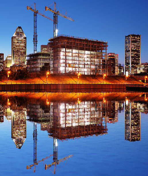 Illuminated Construction Building at Sunset  clear sky night sunset riverbank stock pictures, royalty-free photos & images