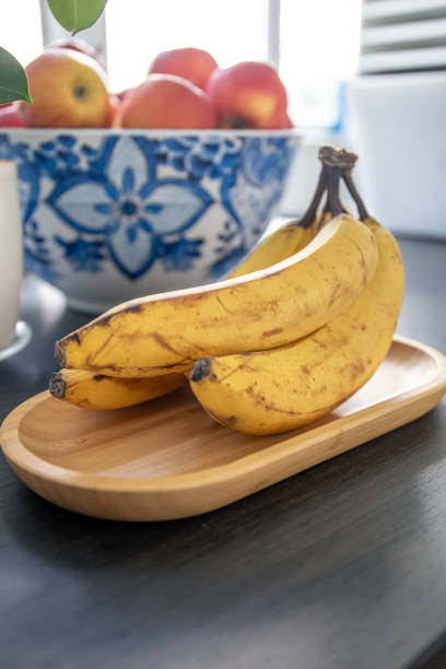 istock Bunch of bananas on kitchen table, close up. 1752296592