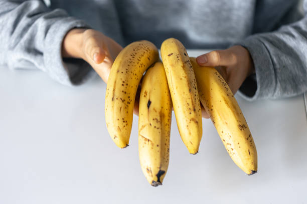 istock Ripe yellow bananas in female hands on a blurred background. 1752297165