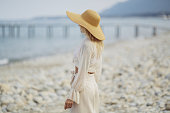 Woman in Elegant Beach Outfit Outdoors Against Sea Background During Summer Vacations