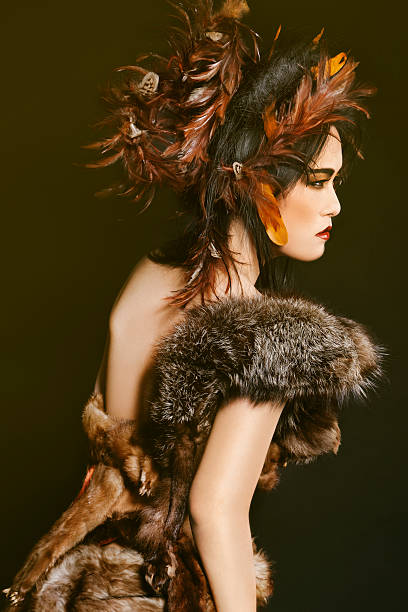 Fashionable and colorful portrait of a beautiful Asian woman wearing fur and feathers.