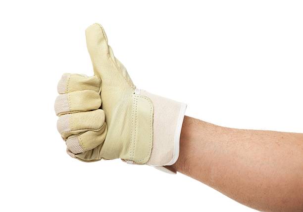 Mid section of male operator removing safety gloves