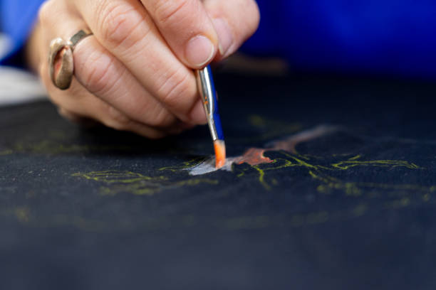 istock Woman hand painting a fabric 1752304699