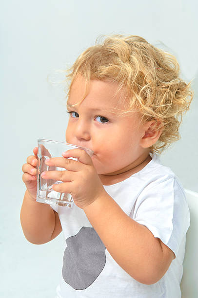 istock Young boy drinking a glass of water 175230518