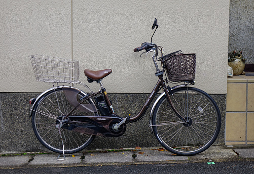 Kyoto, Japan - Nov 28, 2016. A bicycle at house in Kyoto, Japan. Bicycles are widely used in Japan by people of all age groups and social standings.