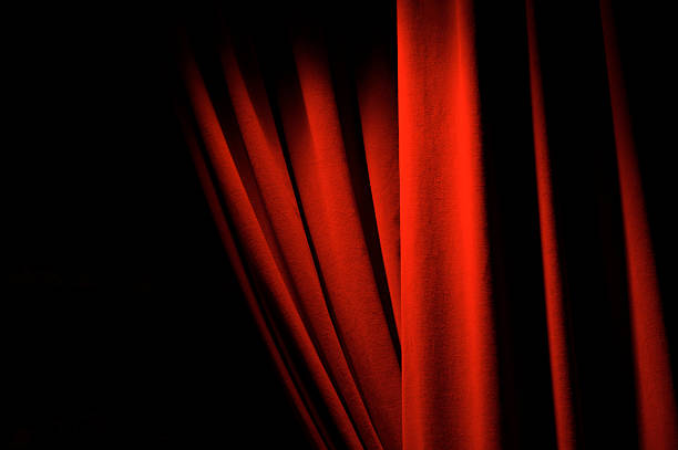 Theatrical Red Velvet Curtains Dramatic Lighting Copy Space stock photo