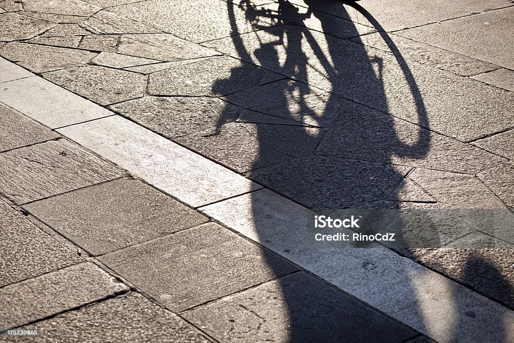 Marble And Stone Flooring With Shadow Of Cyclist "Marble and stone flooring with shadow of cyclist. Duomo square, Milan Italy.See also:" Abstract Stock Photo