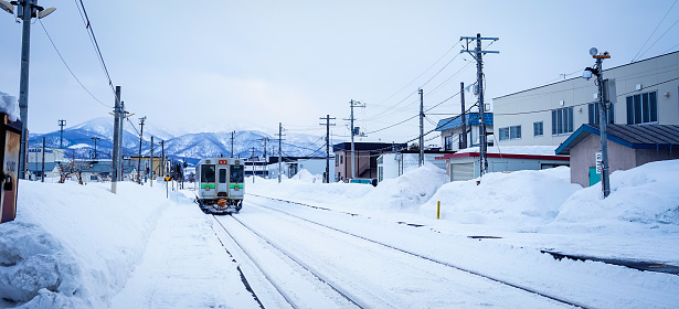 Yoichi, Japan - Feb 4, 2015. A train running on the rail track with snow at winter in Yoichi, Hokkaido, Japan. Yoichi is the home of the Yoichi distillery owned by Nikka Whisky Distilling.