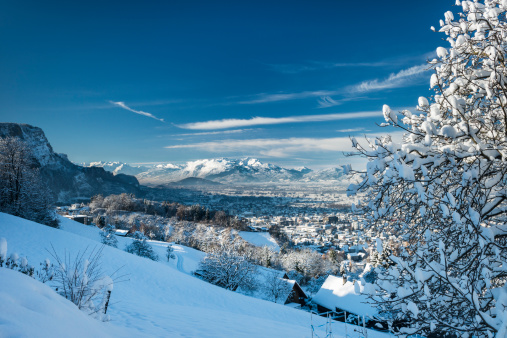 winter landscape in austria with swiss alps in background