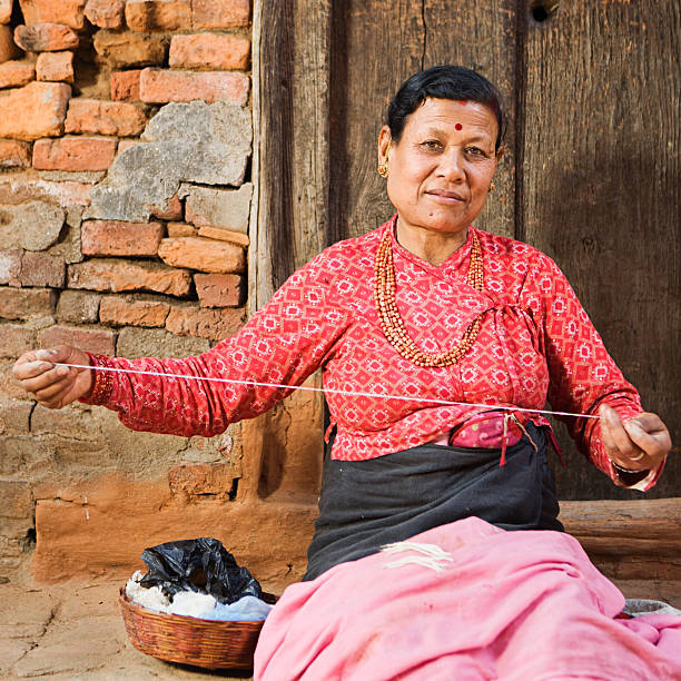 istock Nepali woman spinning the wool 175231112