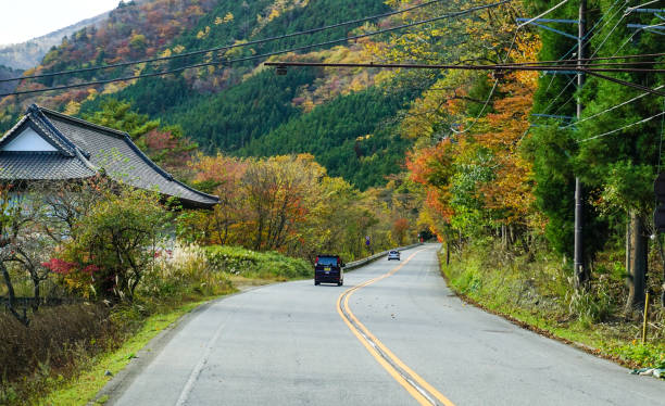 Nikko, Japan - Nov 3, 2014. A car running on mountain road at autumn in Nikko, Japan. Nikko is a popular destination for Japanese and international tourists.