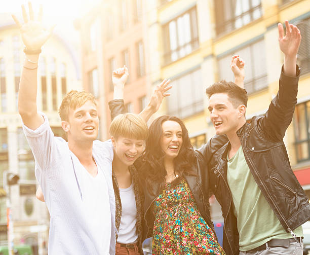 istock friends outdoors embracing with arm raised 175231824