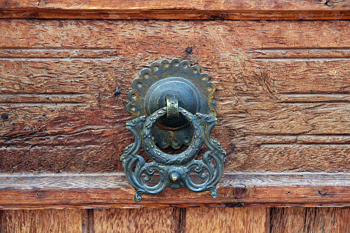 An old metal yard gate with door knob