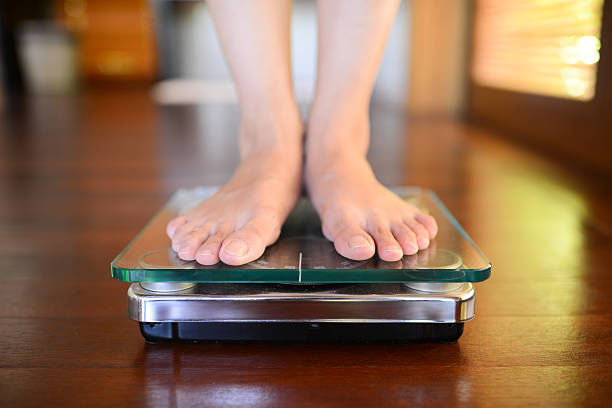 Standing On Weight Scale stock photo
